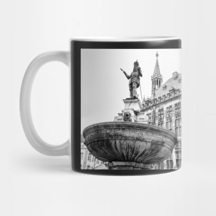 Religious statue with medieval church in the background Mug